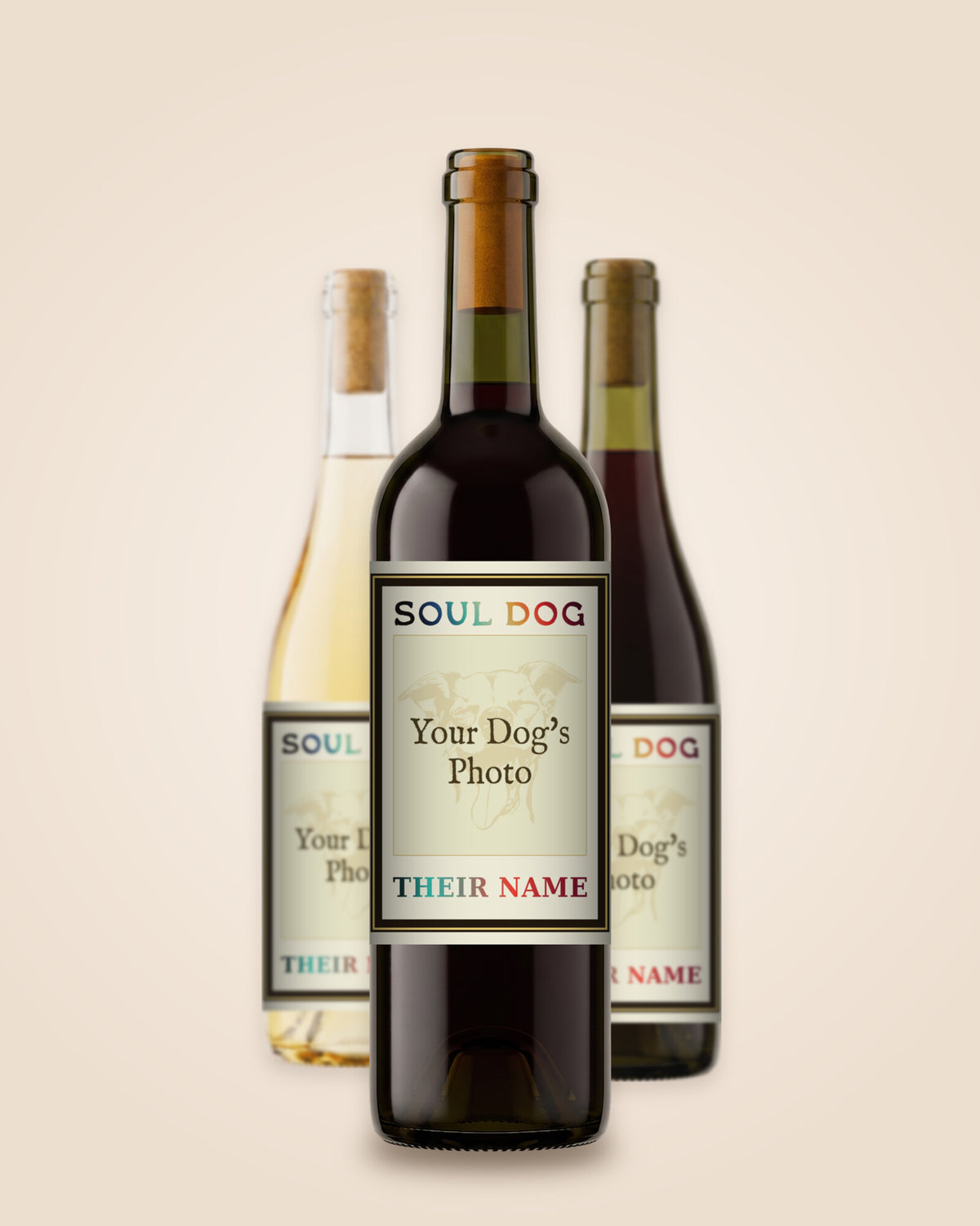 Three bottles, a Cabernet in front with a Chardonnay and a Pinot Noir either side, each with a sample label showing where your dog's photo and name go.