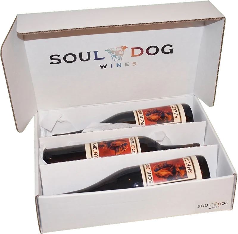 An open Soul Dog Wines gift box holding three bottles.